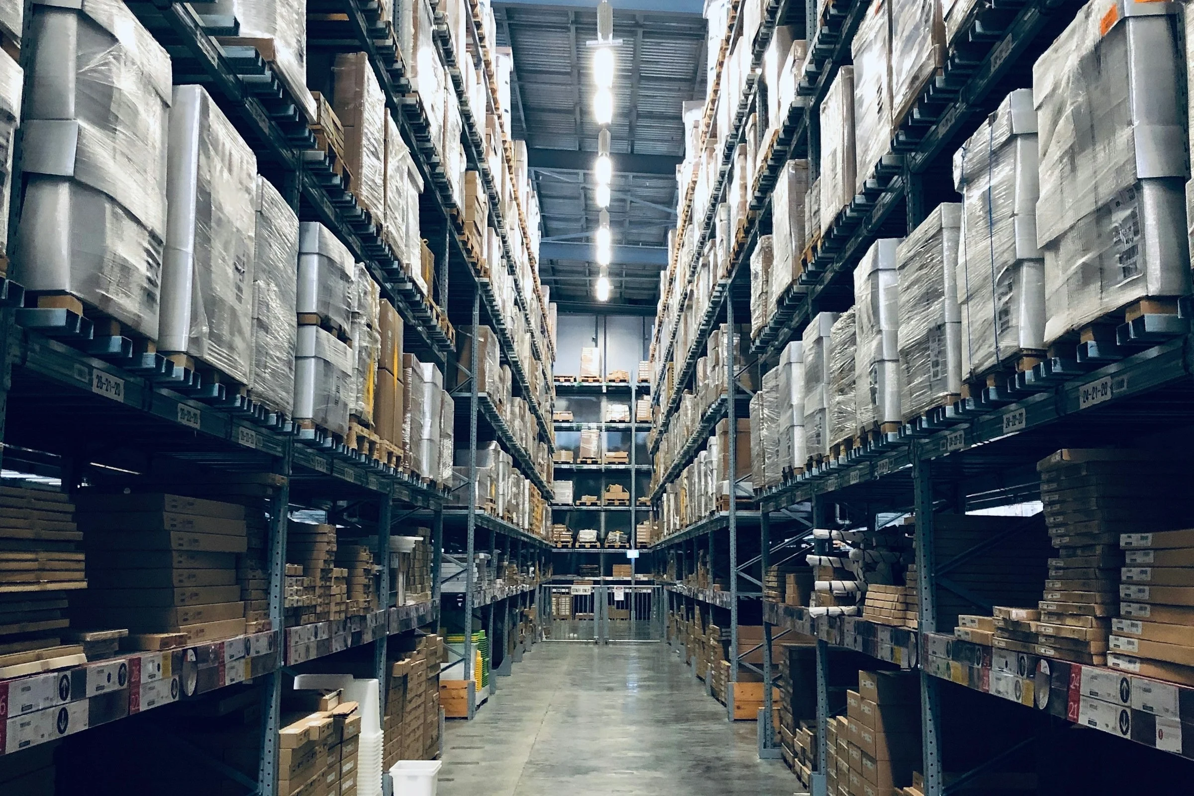 A tall warehouse aisle lined with racking