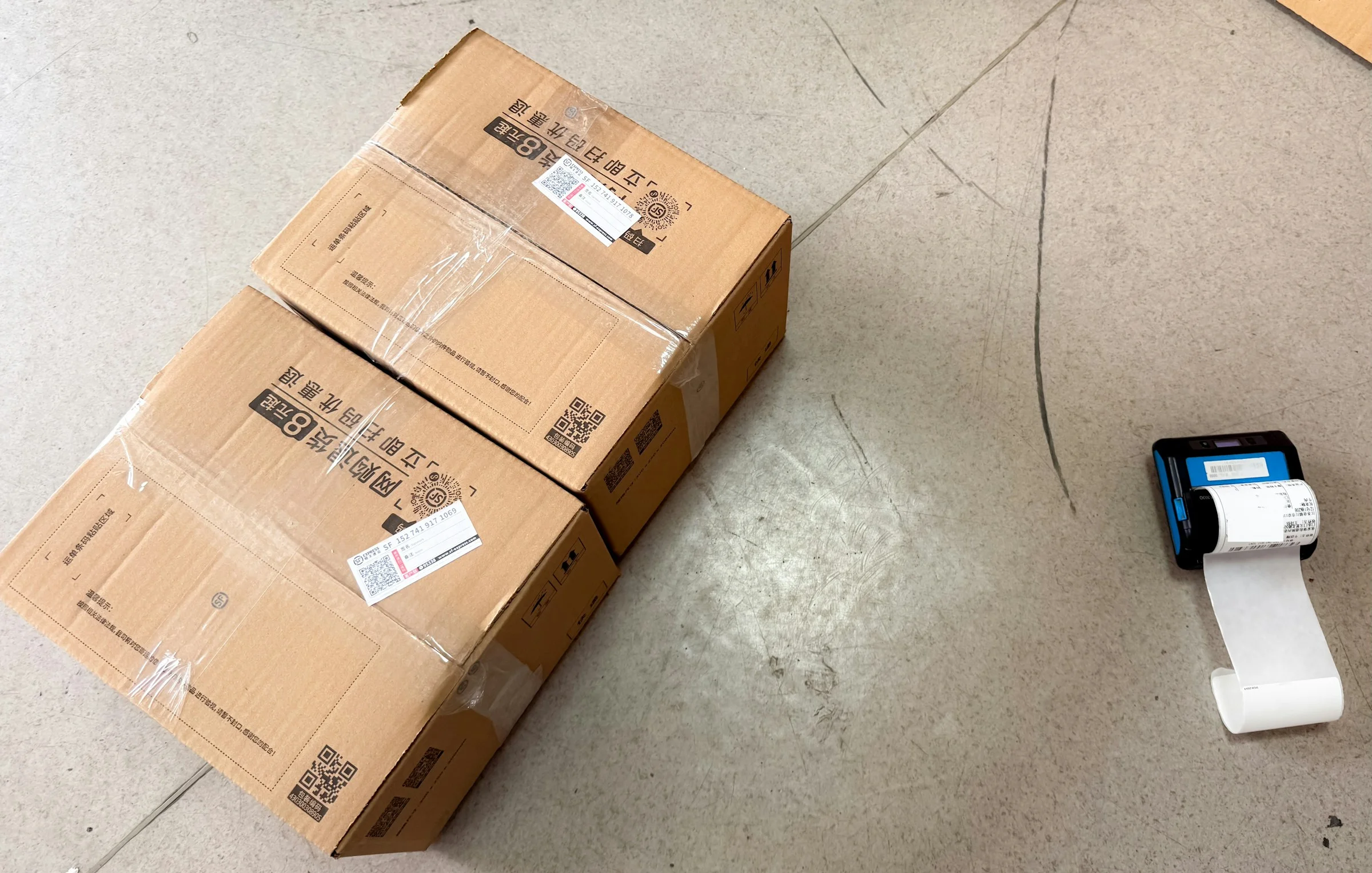 Labelled cartons beside a label printer