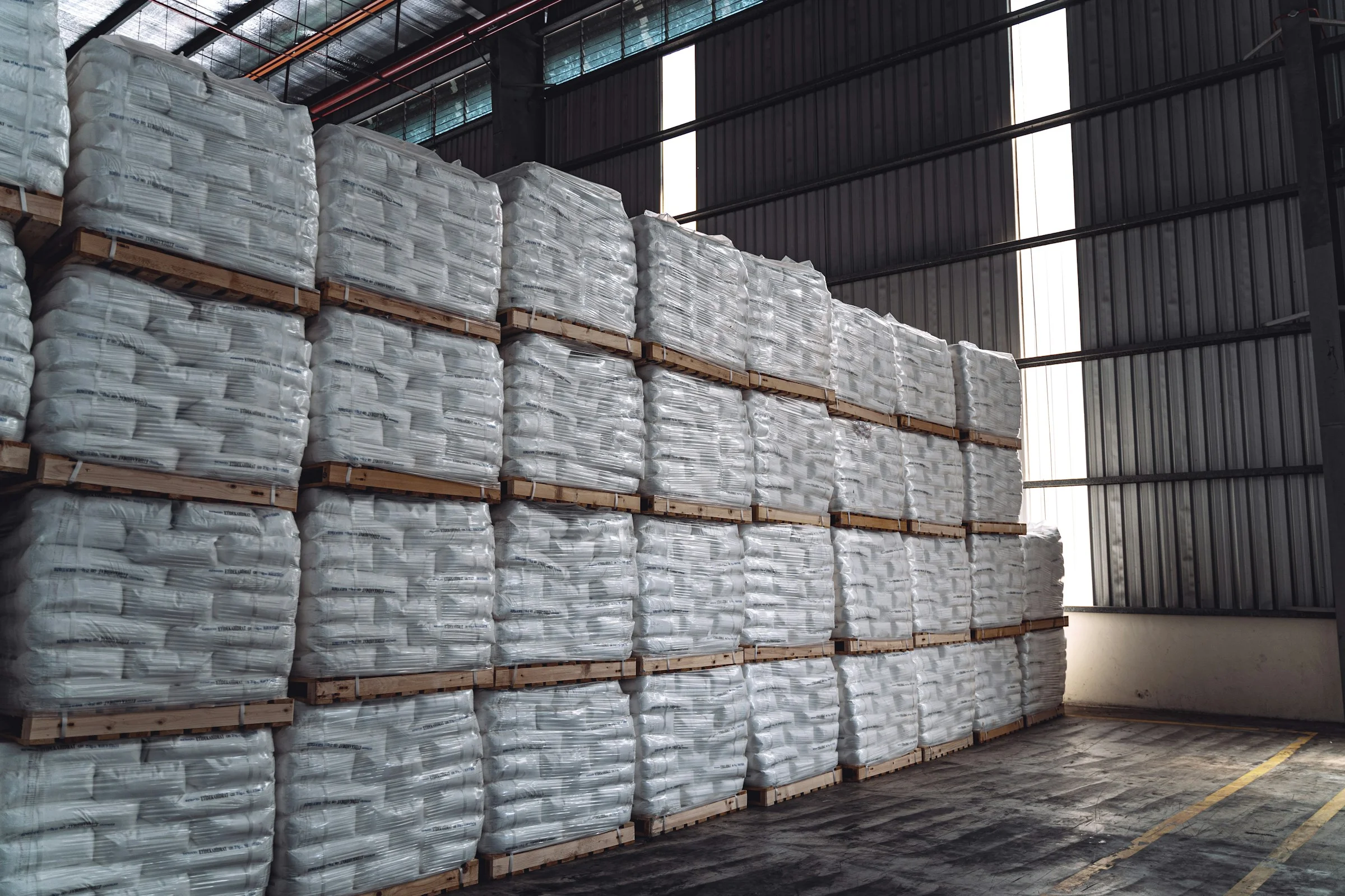Pallets of bagged goods stacked in a warehouse
